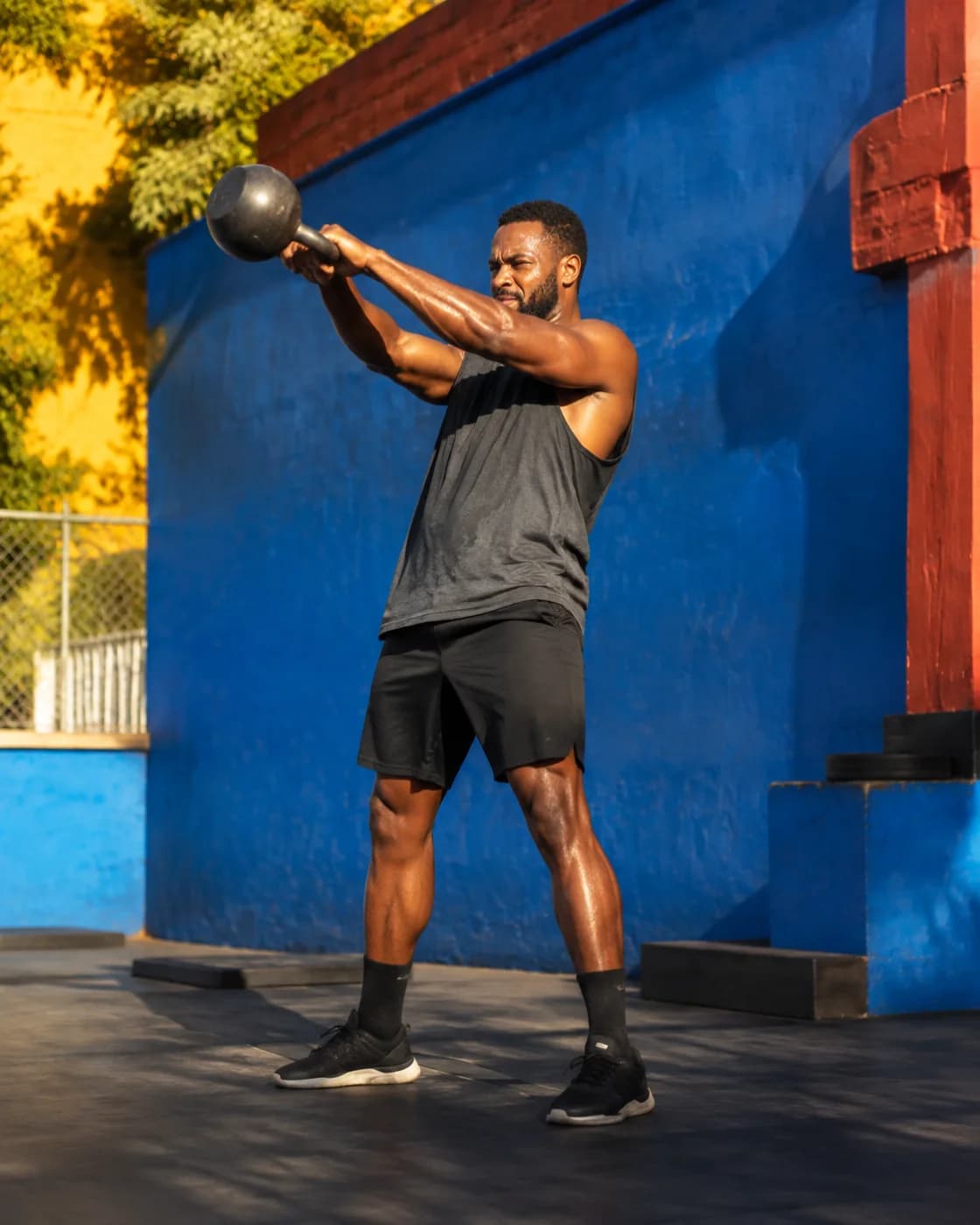 A man training with a kettlebell outdoors